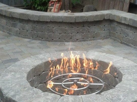 A fire pit by The Legacy Paver Group