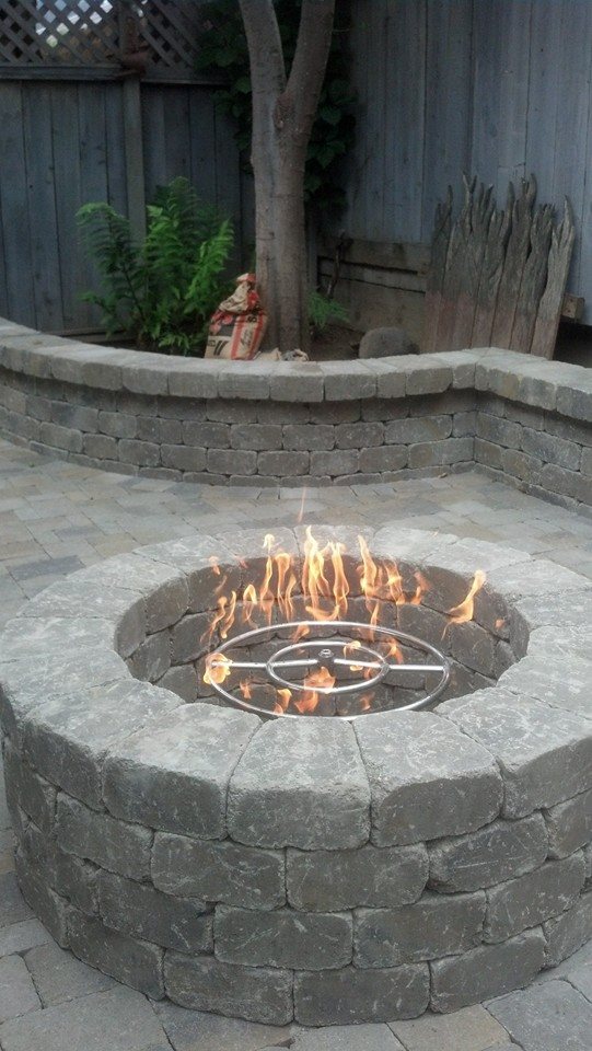 A fire pit by The Legacy Paver Group