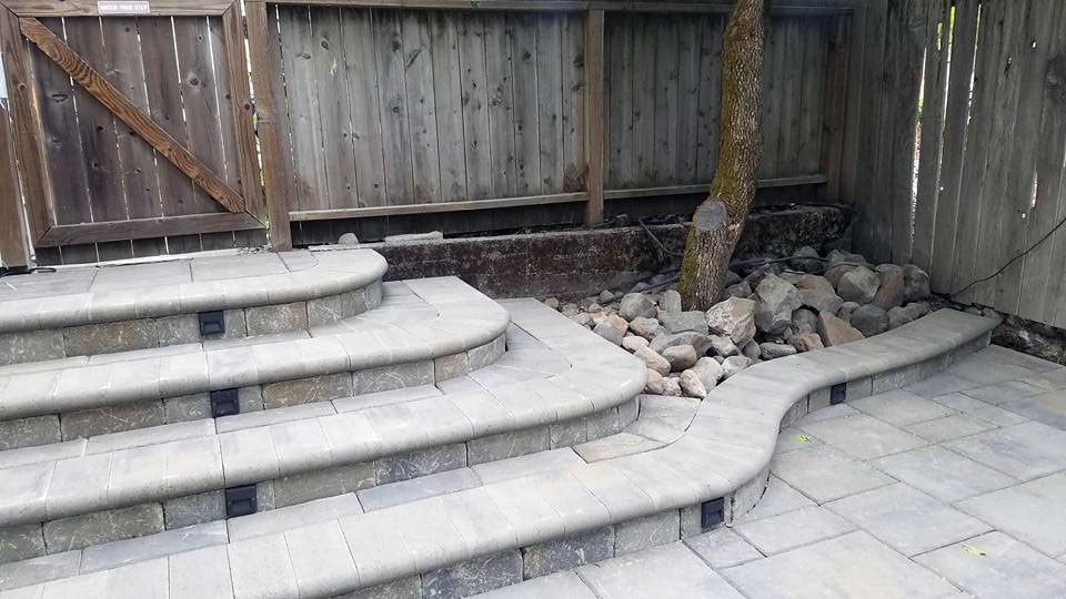 Stone pavers form a functional stairway on this patio project.