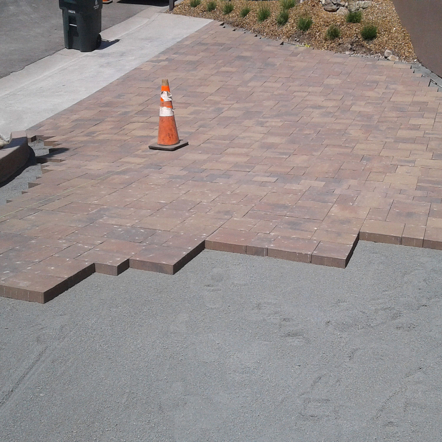 Stone pavers being installed on steep driveway upgrade project.