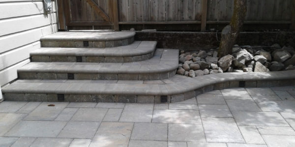 Stepped entry to patio using pavers.